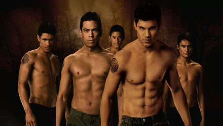 HD desktop wallpaper featuring Jacob Black and the Wolf Pack from The Twilight Saga: New Moon, with Taylor Lautner in the forefront, displaying a forest background with dim lighting.