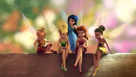 HD desktop wallpaper featuring Tinker Bell and her fairy friends sitting on a wooden ledge with a colorful, blurred background.