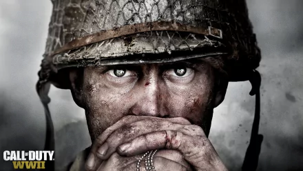 HD desktop wallpaper and background for the video game Call of Duty: WWII, featuring a close-up of a soldier with intense eyes, wearing a helmet and holding dog tags near his face.