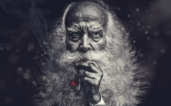 A high-definition wallpaper featuring a bearded man with blue eyes, smoking a pipe. The intense portrait photography creates a captivating, atmospheric background.