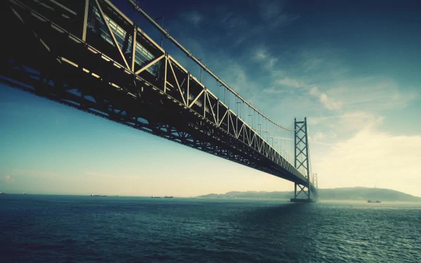 Akashi-Kaikyo Bridge, a man-made structure spanning water near Kobe, Japan, captured in an HD wallpaper view showcasing the Pearl Bridge against a serene sky.
