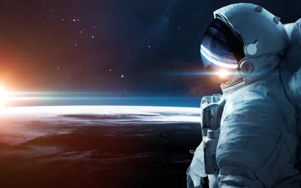 An astronaut in a space suit gazes at a sunrise over a planet surface, with stars dotting the dark space background. This Sci-Fi scene is depicted in HD as a desktop wallpaper.