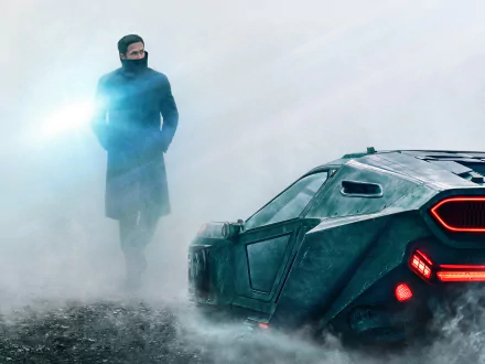 Officer K from Blade Runner 2049, played by Ryan Gosling, stands near a futuristic car in a foggy setting, featured in an HD PC desktop wallpaper.