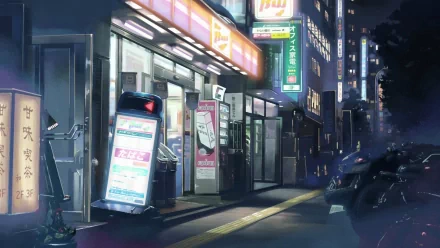 A serene night scene from the anime 5 Centimeters per Second, featuring vibrant city lights and a tranquil street atmosphere, serving as a captivating HD desktop wallpaper.
