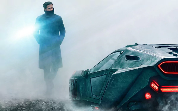 Officer K from Blade Runner 2049, played by Ryan Gosling, stands near a futuristic car in a foggy setting, featured in an HD PC desktop wallpaper.