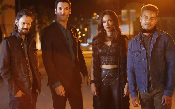 HD wallpaper featuring Robert Ri'chard, Jeremy Davies, Lesley-Ann Brandt, and Tom Ellis from the TV show Lucifer. The cast is standing outdoors together at night, with a cityscape blurred in the background.