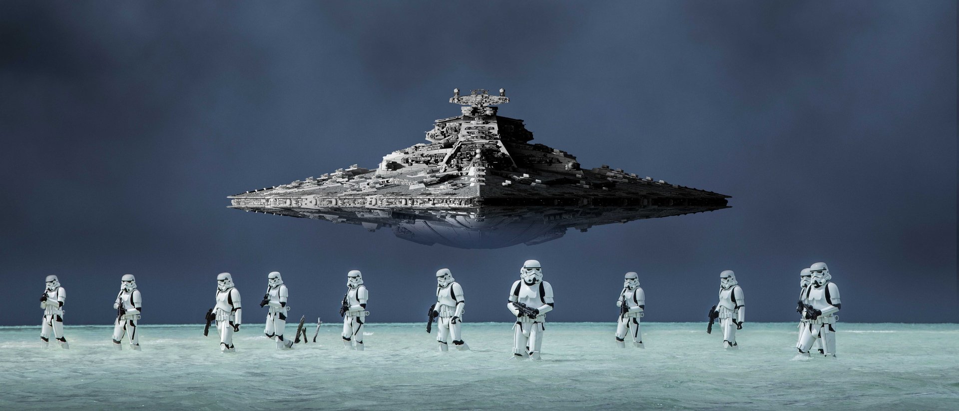 HD PC wallpaper featuring stormtroopers standing below a Star Destroyer from Rogue One: A Star Wars Story, set against a dark, moody background.