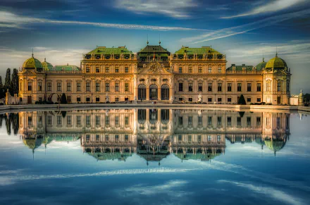 A stunning architectural view of a grand palace in Vienna, Austria, perfectly reflected in calm water, captured in HD for a striking desktop wallpaper.