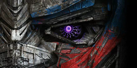 Close-up of a Transformers robot eye from the movie Transformers: The Last Knight, featured in an HD desktop wallpaper. The robot's intricate metallic textures and vibrant colors are prominently displayed.