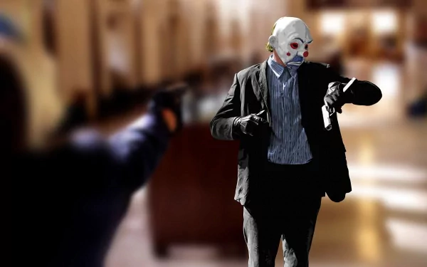 A high-definition wallpaper featuring the Joker from *The Dark Knight*, wearing a clown mask and suit, holding a Glock with an intense background scene.