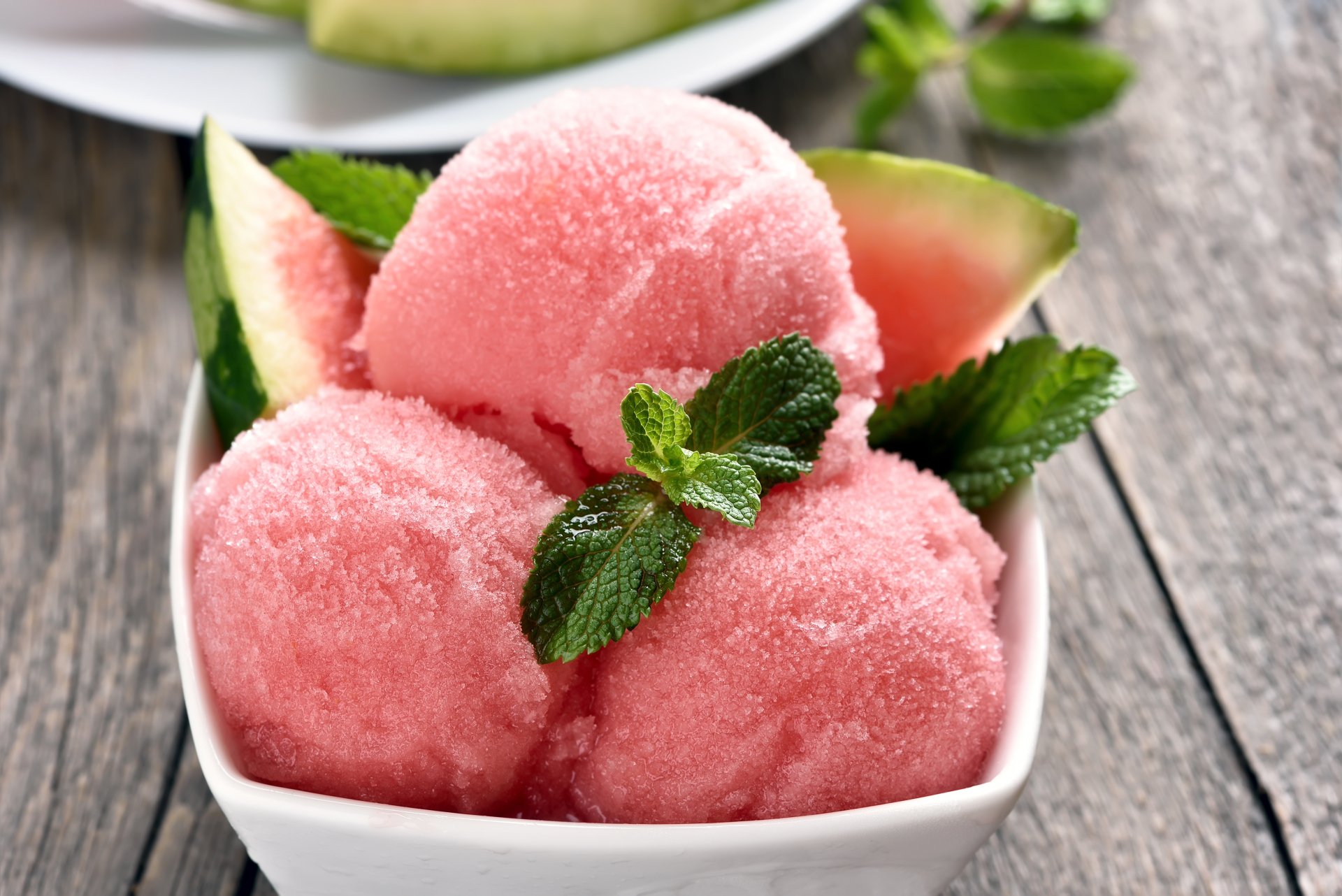 A 4K Ultra HD PC desktop wallpaper featuring three scoops of pink watermelon ice cream garnished with mint leaves and watermelon slices in a white bowl.