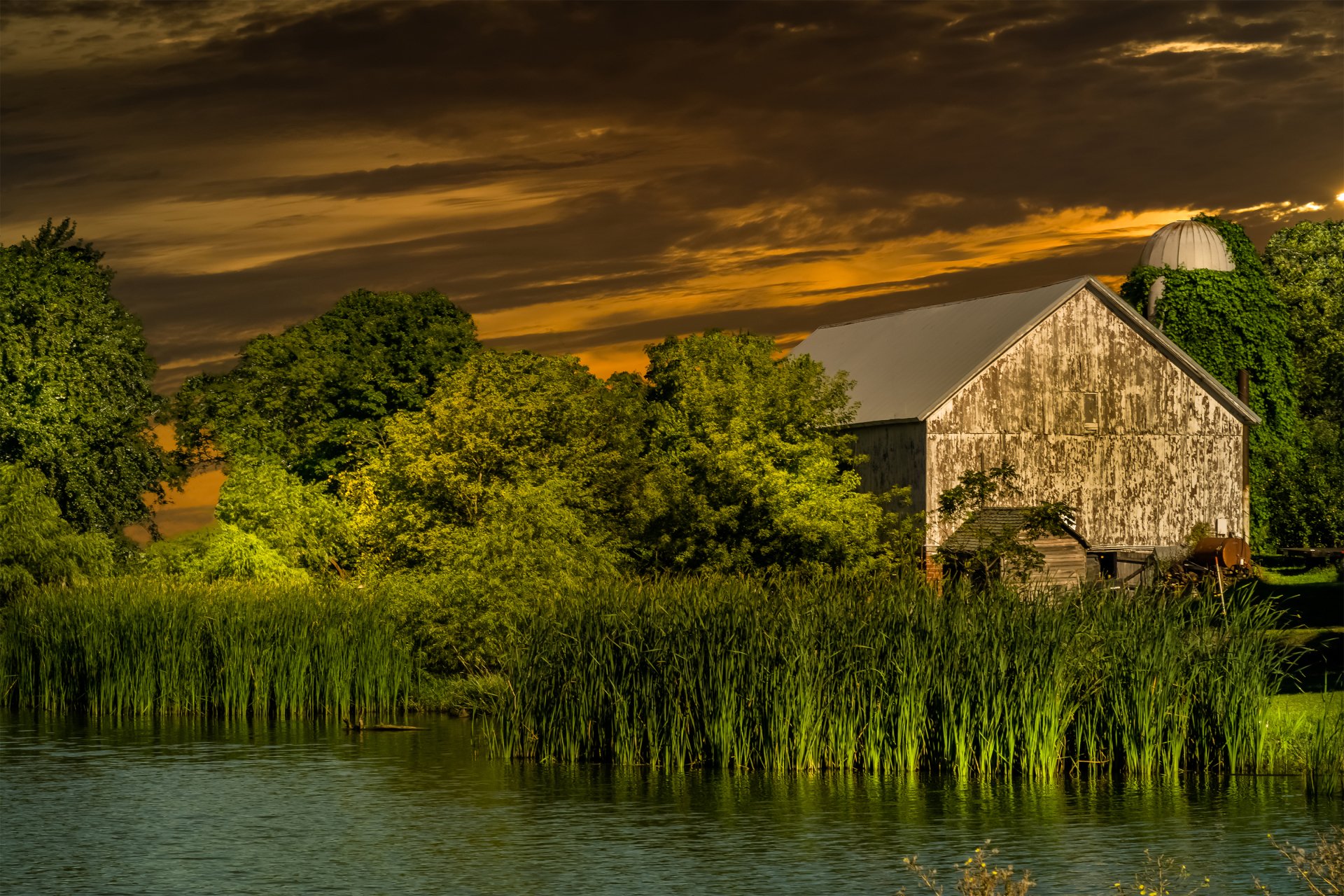 What is the title of this picture ? Sunset over Farm and River HD Wallpaper | Background Image | 3360x2240