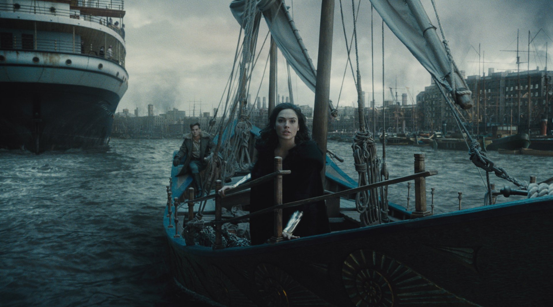 HD desktop wallpaper featuring characters Steve Trevor (played by Chris Pine) and Wonder Woman (played by Gal Gadot) on a boat, in a scene from the movie Wonder Woman with a misty city in the background.