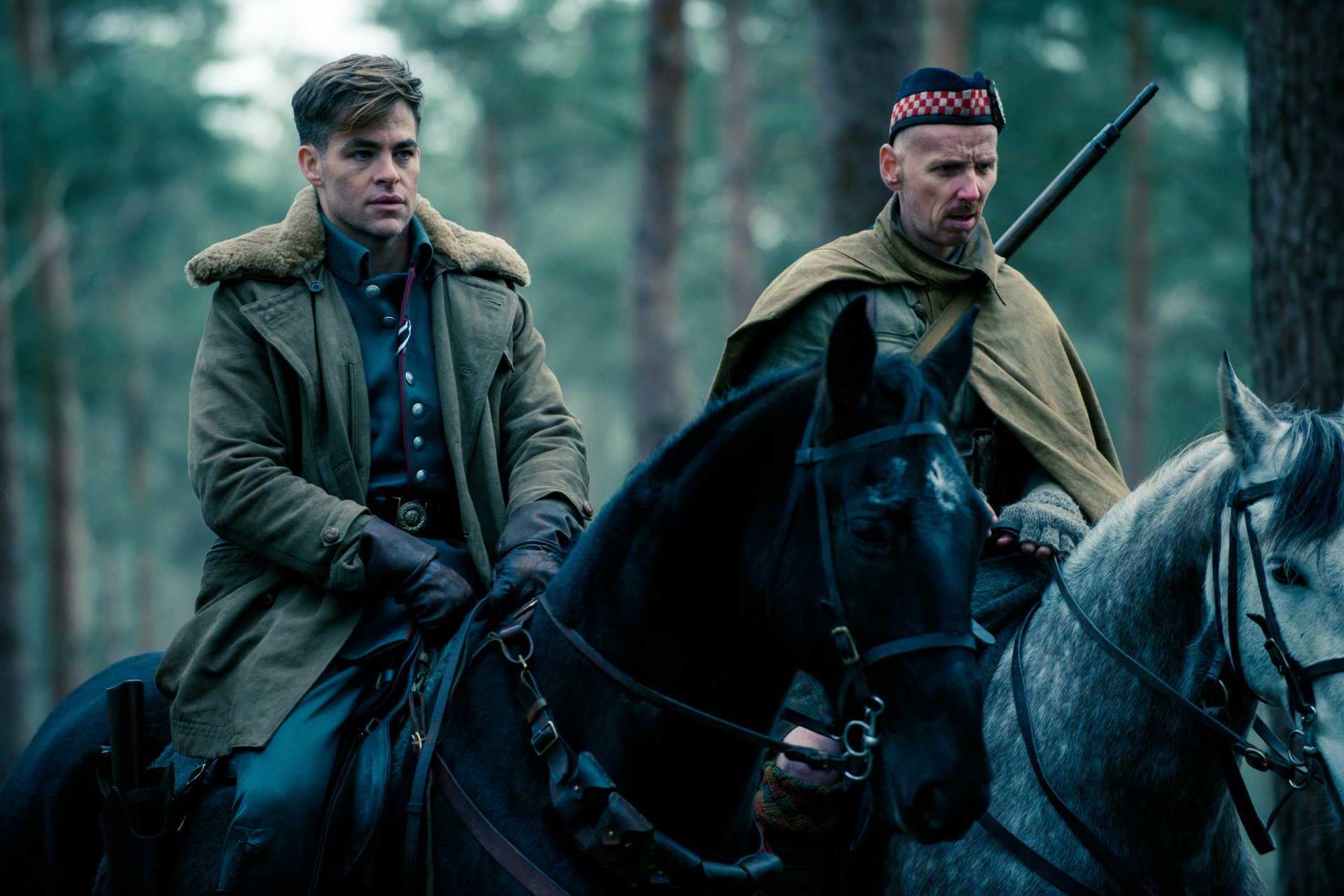 HD desktop wallpaper featuring Steve Trevor (Chris Pine) from the movie Wonder Woman, depicting him and another rider on horses in a forest setting.