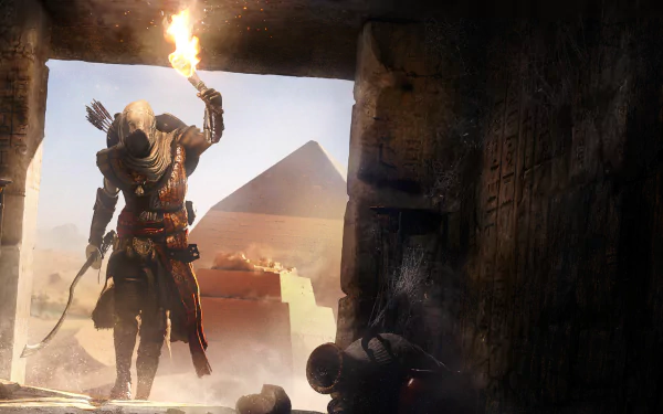 HD desktop wallpaper featuring Bayek of Siwa from the video game Assassin's Creed Origins, holding a torch and standing at the entrance of a dark tomb with a pyramid in the background.
