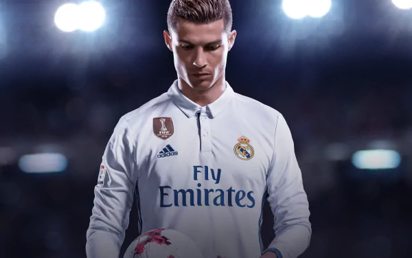 HD desktop wallpaper and background featuring Cristiano Ronaldo in his Real Madrid kit, from the video game FIFA 18, holding a soccer ball with stadium lights illuminating the scene.