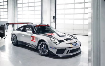 Porsche 911 GT3 Cup supercar in silver livery parked in a bright garage — high-resolution 2K Quad HD PC desktop wallpaper/background.