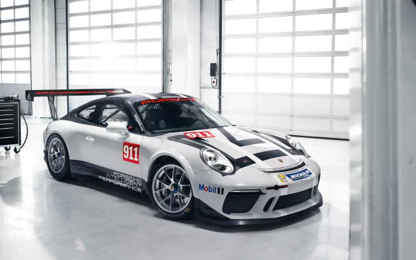 Porsche 911 GT3 Cup supercar in silver livery parked in a bright garage — high-resolution 2K Quad HD PC desktop wallpaper/background.