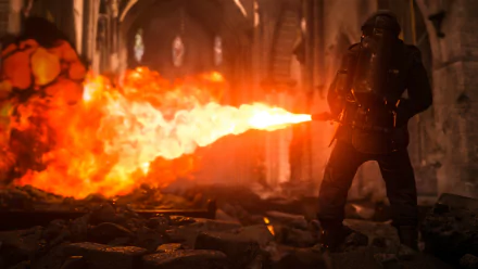 HD wallpaper of Call of Duty: WWII featuring a soldier in action with a flamethrower, set in a fiery, war-torn scene inside a decaying building.