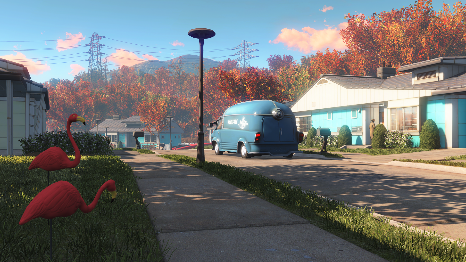 HD PC desktop wallpaper from the video game Fallout 4, depicting a peaceful suburban street with autumn foliage, flamingo lawn ornaments, and a retro blue bus.