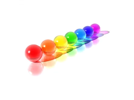 A vibrant HD desktop wallpaper featuring a row of colorful spheres arranged in a gradient from red to violet against a white background.
