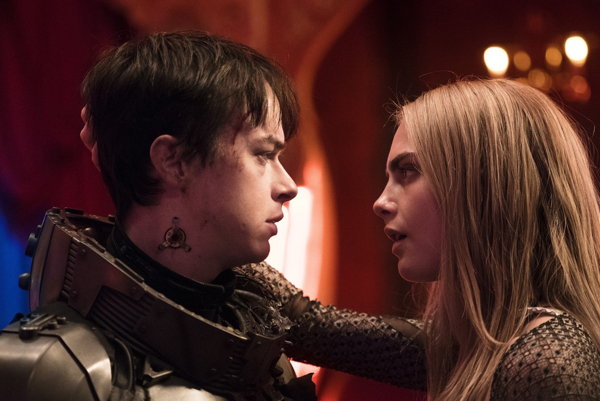 Blonde Cara Delevingne and Dane DeHaan in a close moment from the movie Valerian and the City of a Thousand Planets, captured in an HD PC desktop wallpaper.