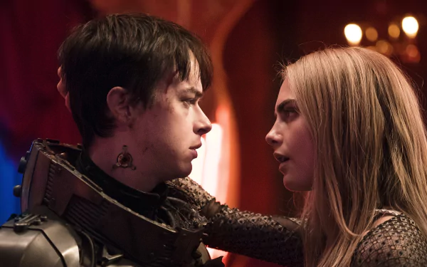 Blonde Cara Delevingne and Dane DeHaan in a close moment from the movie Valerian and the City of a Thousand Planets, captured in an HD PC desktop wallpaper.
