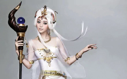 A captivating white sorceress in a flowing gown, adorned with intricate jewelry and holding a staff, embodies fantasy and magic in this HD desktop wallpaper.