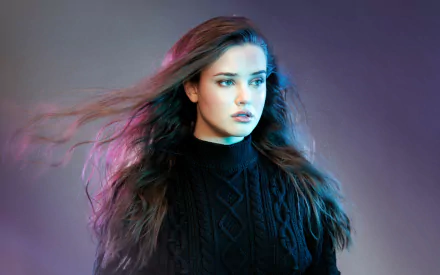 HD desktop wallpaper featuring Australian actress Katherine Langford with brunette hair and blue eyes, captured in a dramatic and colorful setting.
