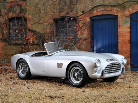 Silver AC Ace roadster, classic AC Cars sports vehicle parked by a brick wall — HD PC desktop wallpaper background.