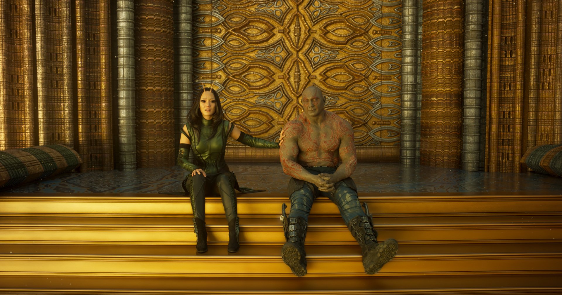 HD PC wallpaper of Dave Bautista as Drax and Pom Klementieff as Mantis from Guardians of the Galaxy Vol. 2, set against an ornate golden background.
