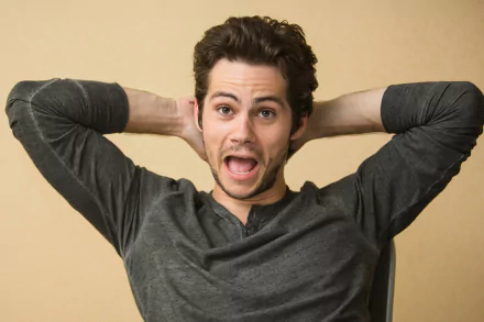 HD wallpaper featuring a jovial man with hands behind his head, making for a lively desktop background.