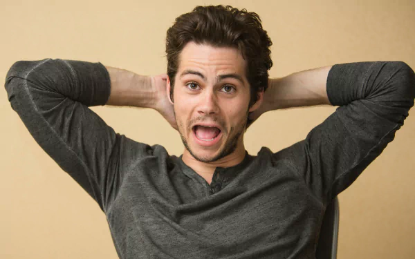 HD wallpaper featuring a jovial man with hands behind his head, making for a lively desktop background.
