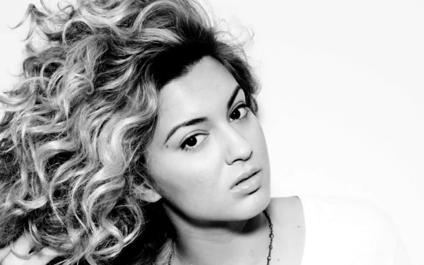 HD desktop wallpaper and background featuring a black and white portrait of Tori Kelly with voluminous curly hair.