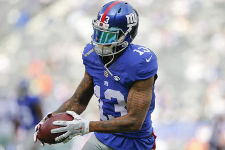 HD wallpaper of a New York Giants player catching a football on the field, representing Odell Beckham Jr.