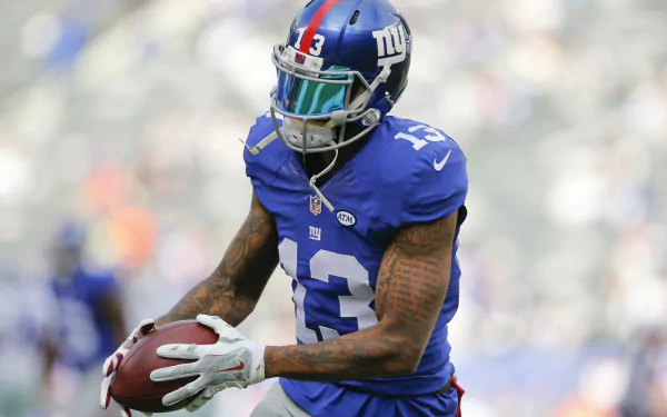 HD wallpaper of a New York Giants player catching a football on the field, representing Odell Beckham Jr.