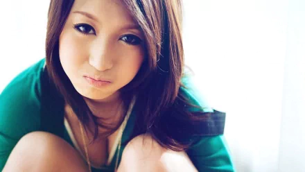 A close-up of a pretty woman with long, straight hair, looking thoughtfully at the camera, set against a bright background. This image serves as an HD desktop wallpaper.