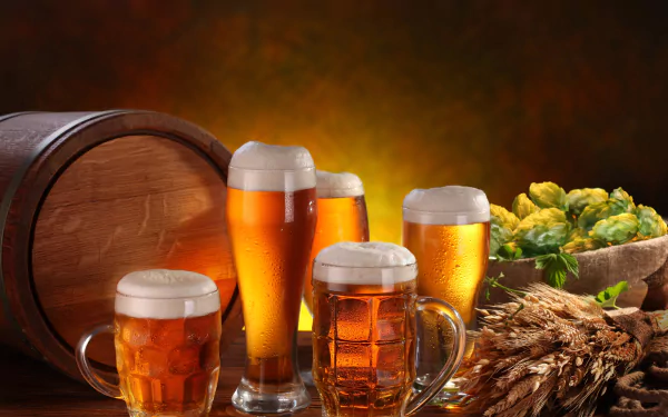 A 4K Ultra HD still life desktop wallpaper featuring glasses of beer, a wooden barrel, hops, and barley arranged together on a warm-toned background.