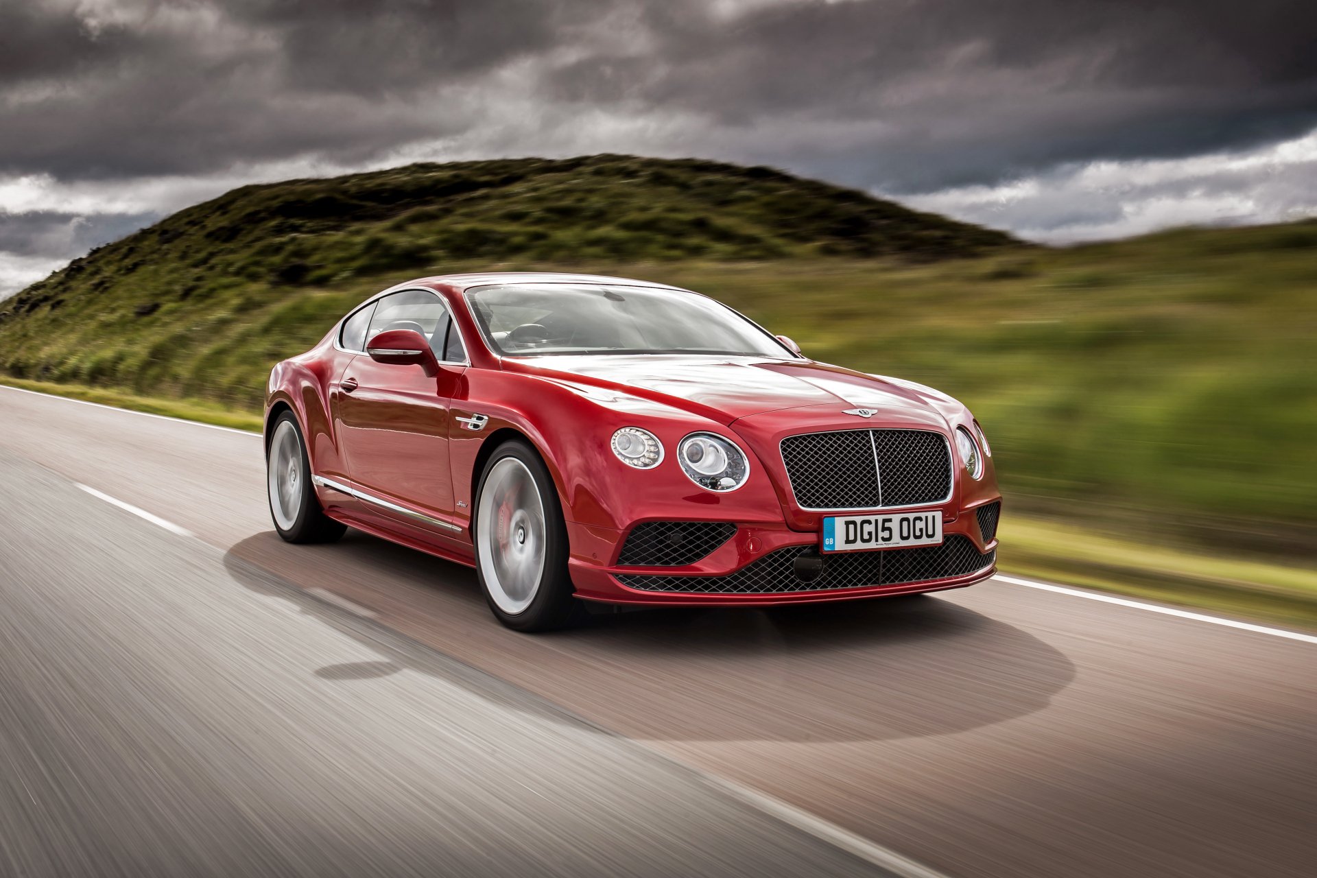 Red Bentley Continental coupe driving on an open road — luxury car and vehicle captured in motion as a 4K Ultra HD PC desktop wallpaper background.