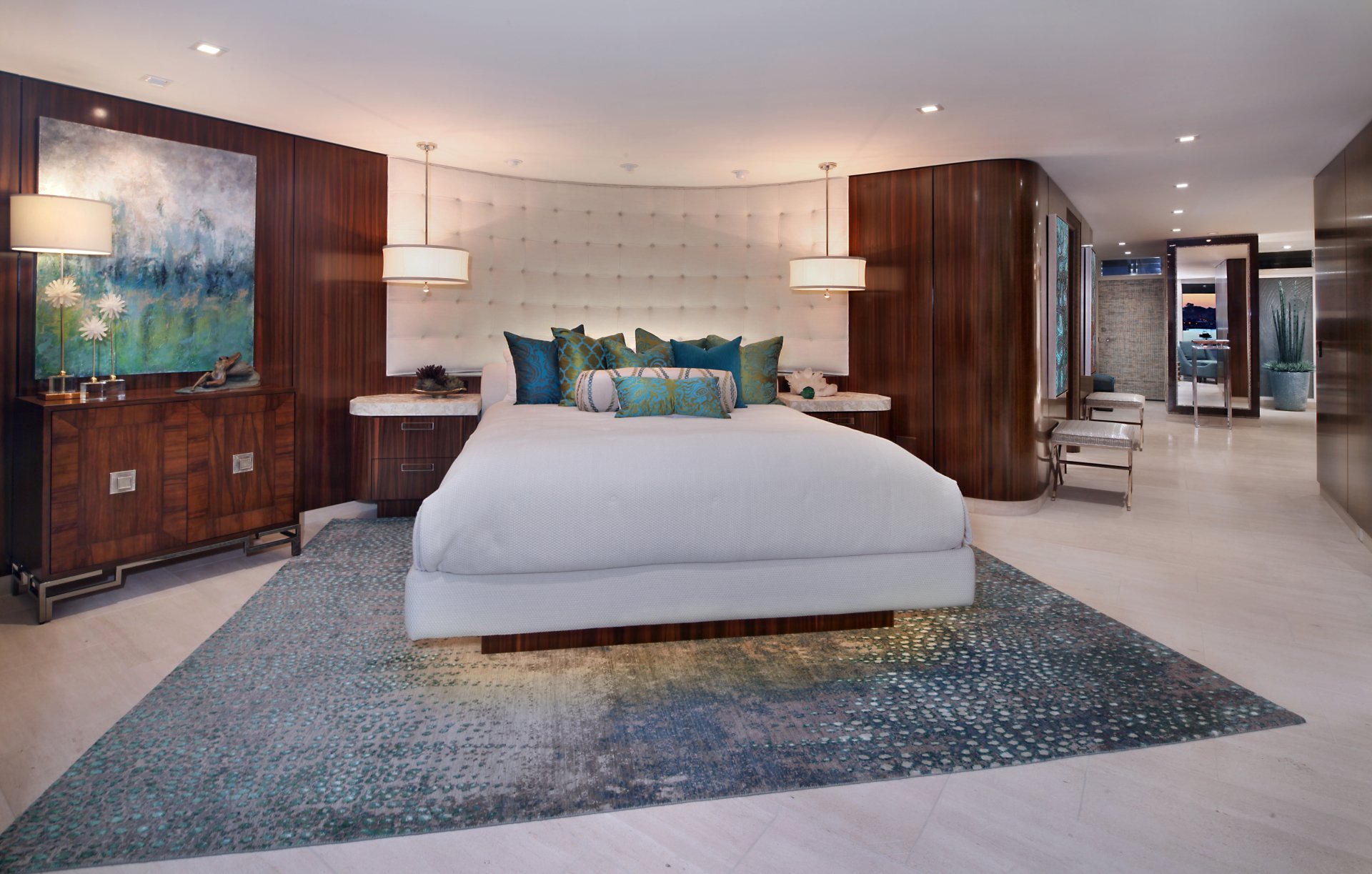 A modern bedroom features a large bed with plush pillows, rich wood paneling, soft lighting, and contemporary furniture, captured in a 4K Ultra HD desktop wallpaper.