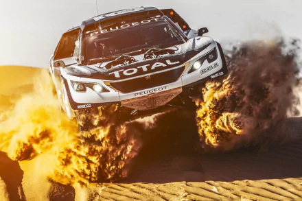 A rally car kicking up sand while airborne on a desert track, captured in dynamic motion as an HD PC desktop wallpaper and sports background.
