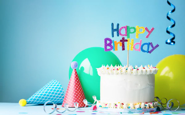 HD desktop wallpaper featuring a vibrant birthday scene with a colorful Happy Birthday cake, party hats, and balloons against a light blue background.