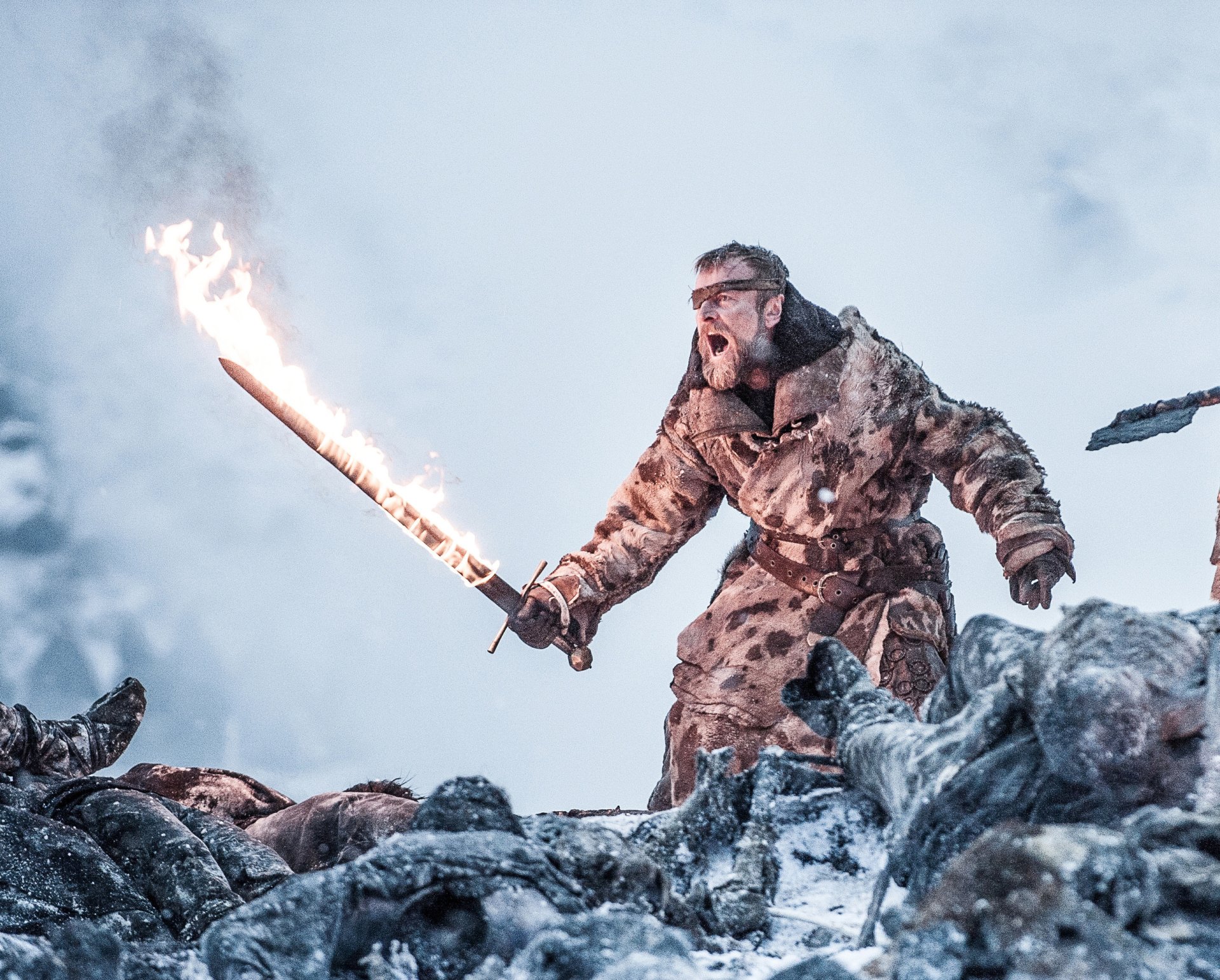 Richard Dormer as Beric Dondarrion from Game of Thrones, wielding a flaming sword amid a snowy battlefield in this HD TV show desktop wallpaper.