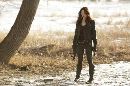 Melanie Scrofano as a character from the TV show Wynonna Earp stands outdoors on a 4K Ultra HD PC desktop wallpaper background.