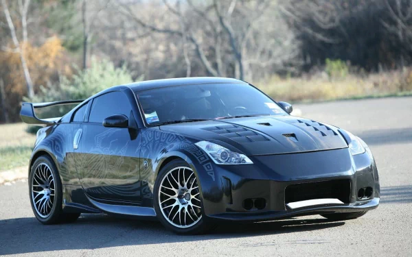 HD PC desktop wallpaper featuring a sleek black Nissan 350Z sports car parked on a road with a blurred natural background.