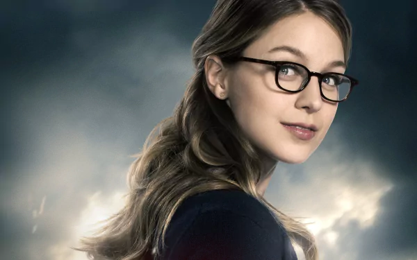 HD desktop wallpaper featuring Melissa Benoist as Kara Danvers from the TV show Supergirl, showcasing her in glasses with a cloudy background.