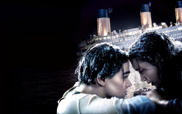 HD wallpaper from the movie Titanic showing Leonardo DiCaprio and Kate Winslet in an emotional scene with the sinking Titanic in the background.
