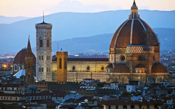 HD desktop wallpaper showcasing the iconic Florence Cathedral with its dome and bell tower, set against the serene backdrop of Florence, Italy at dusk.