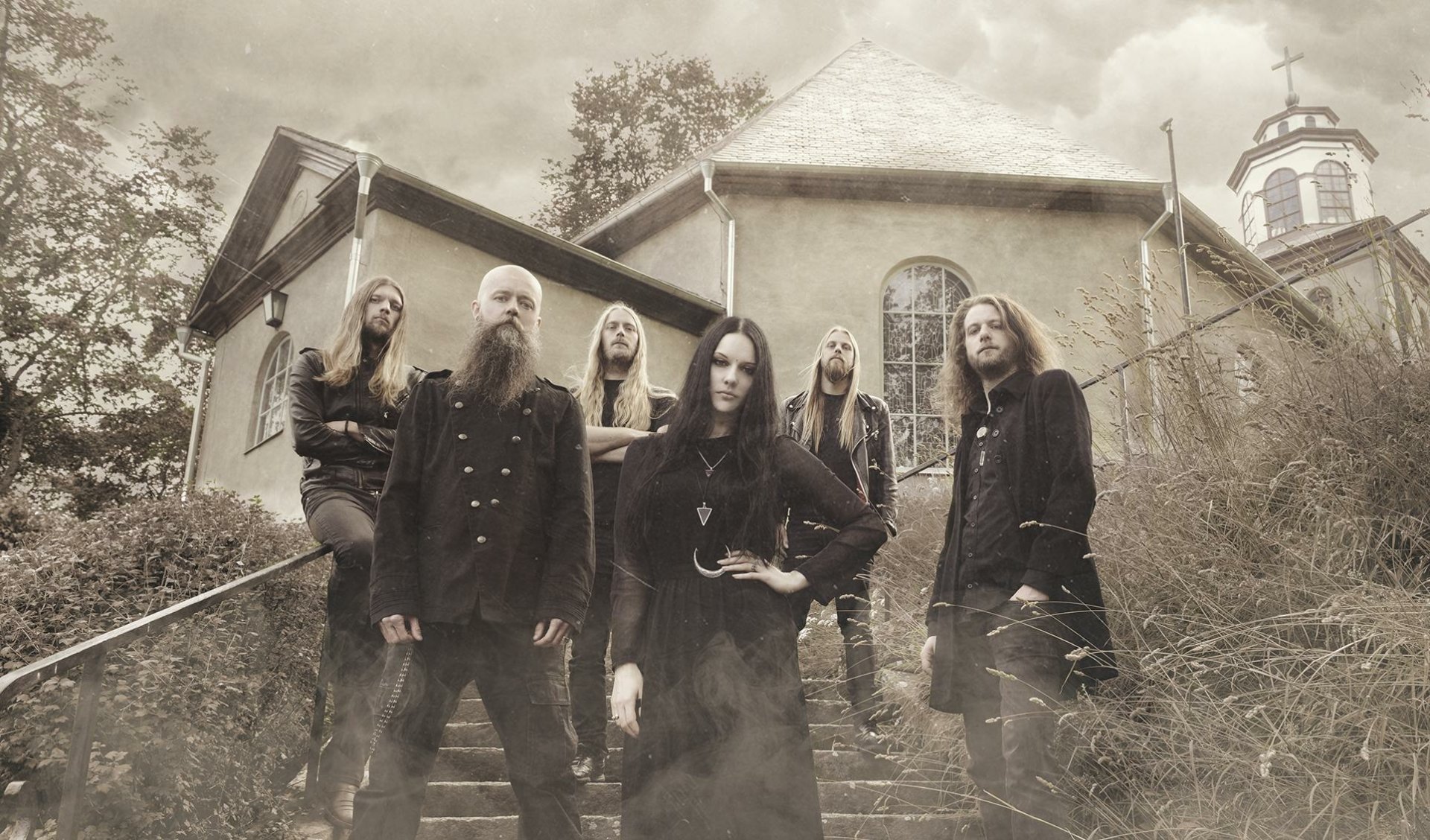 HD PC desktop wallpaper of gothic doom metal band Draconian on church steps, seven members in dark clothing in moody sepia tones — a music band promotional image.