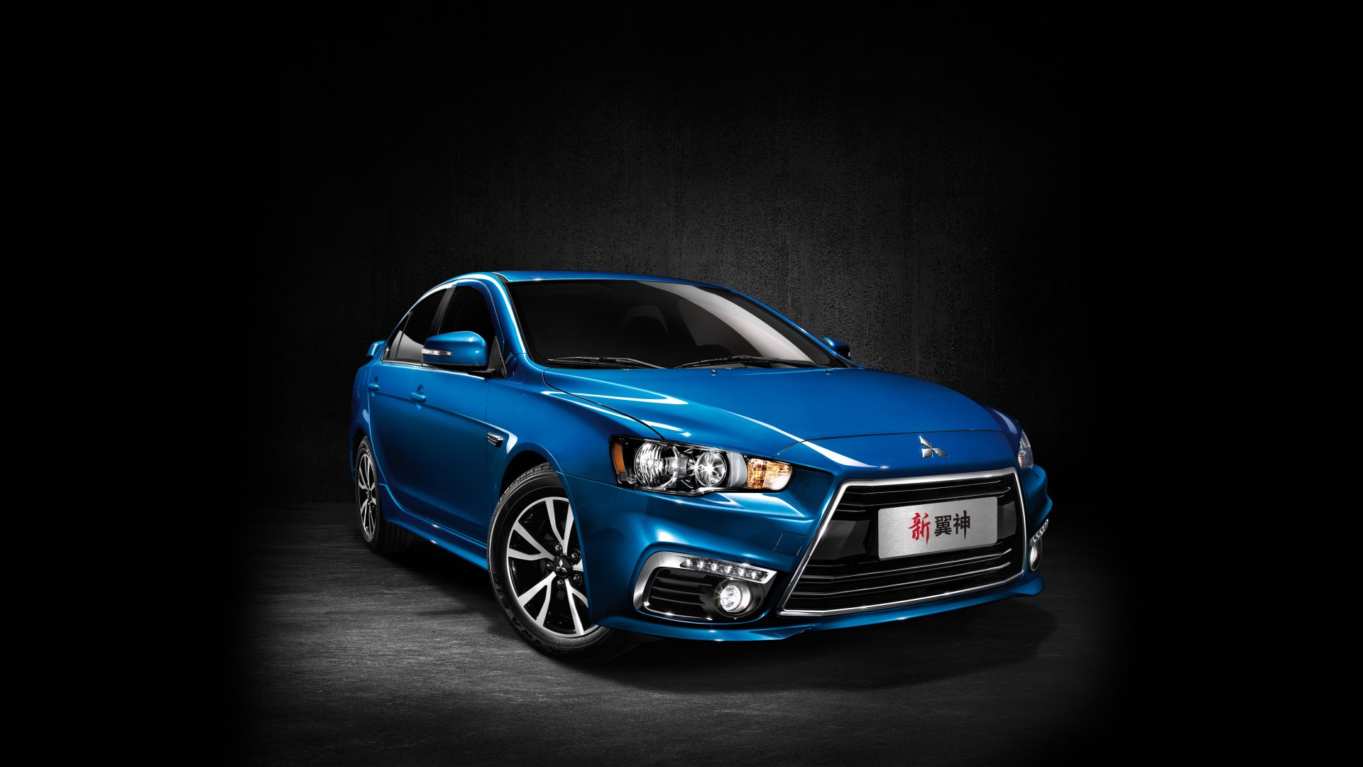 Blue Mitsubishi Lancer compact car on a dark textured backdrop — 5K Ultra HD PC desktop wallpaper and background of the vehicle.